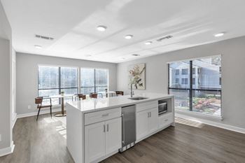 An open kitchen and dining room with a large window